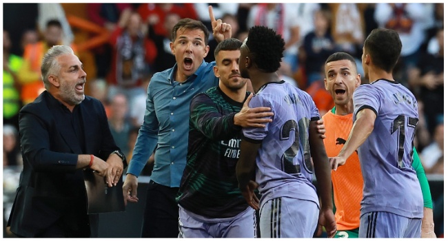 Real Madrid's Brazilian forward Vinicius Junior (3R) confronts Valencia's officials as he leaves after being sent off the pitch by the referee during the Spanish league football match between Valencia CF and Real Madrid CF at the Mestalla stadium in Valencia on May 21, 2023. (Photo by JOSE JORDAN/AFP/)