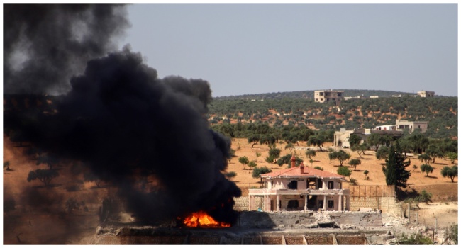 A plume of smoke rises from a building following a reported Russian air strike on Syria's northwestern rebel-held Idlib province, on June 25, 2023. The strikes killed at least seven people, including four civilians, in retaliation for deadly drone attacks blamed on rebel forces, a war monitor said. (Photo by Abdulaziz KETAZ / AFP) RELATED CONTENT