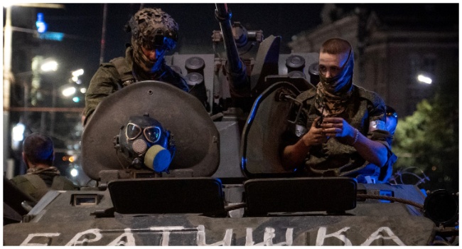 Members of Wagner group looks from a military vehicle with the sign read as "Brother" in Rostov-on-Don late on June 24, 2023. (Photo by Roman ROMOKHOV/ AFP)