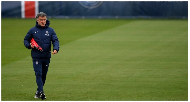 Paris Saint-Germain's French head coach Christophe Galtier walks on the pitch with the club's logo in the background during a training session at Saint-Germain-en-Laye, in the north-western outskirts of Paris on May 12, 2023, two days prior to the L1 football match against Ajaccio. (Photo by FRANCK FIFE / AFP)