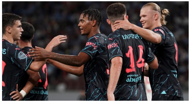 Manchester City defender Aymeric Laporte (2R) celebrates with teammates after his goal during the International friendly football match between Bayern Munich of Germany and Manchester City of England at the National Stadium in Tokyo on July 26, 2023. (Photo by Kazuhiro NOGI / AFP)