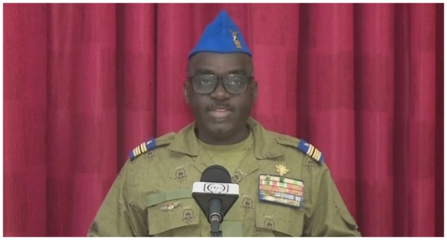 This video frame grab image obtained by AFP from Télé Sahel on August 13, 2023 shows Colonel Major Amadou Abdramane, a CNSP (Conseil national pour la sauvegarde de la patrie) member, reading a statement on national television. (Credit: AFP)