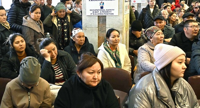 This handout photograph taken and released by Kazakhstan’s Presidential Press Service on October 28, 2023, shows employees and relatives of miners listening to a speech by Kazakhstan’s President at the Kostyenko coal mine in Karaganda. (Photo by Handout / KAZAKHSTAN’S PRESIDENTIAL PRESS SERVICE / AFP).