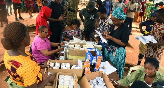 Officials of the Independent National Electoral Commission (INEC) sort voters card at a ward in Lagos on January 13, 2023 ahead of February 25 presidential election. (Photo by PIUS UTOMI EKPEI / AFP)