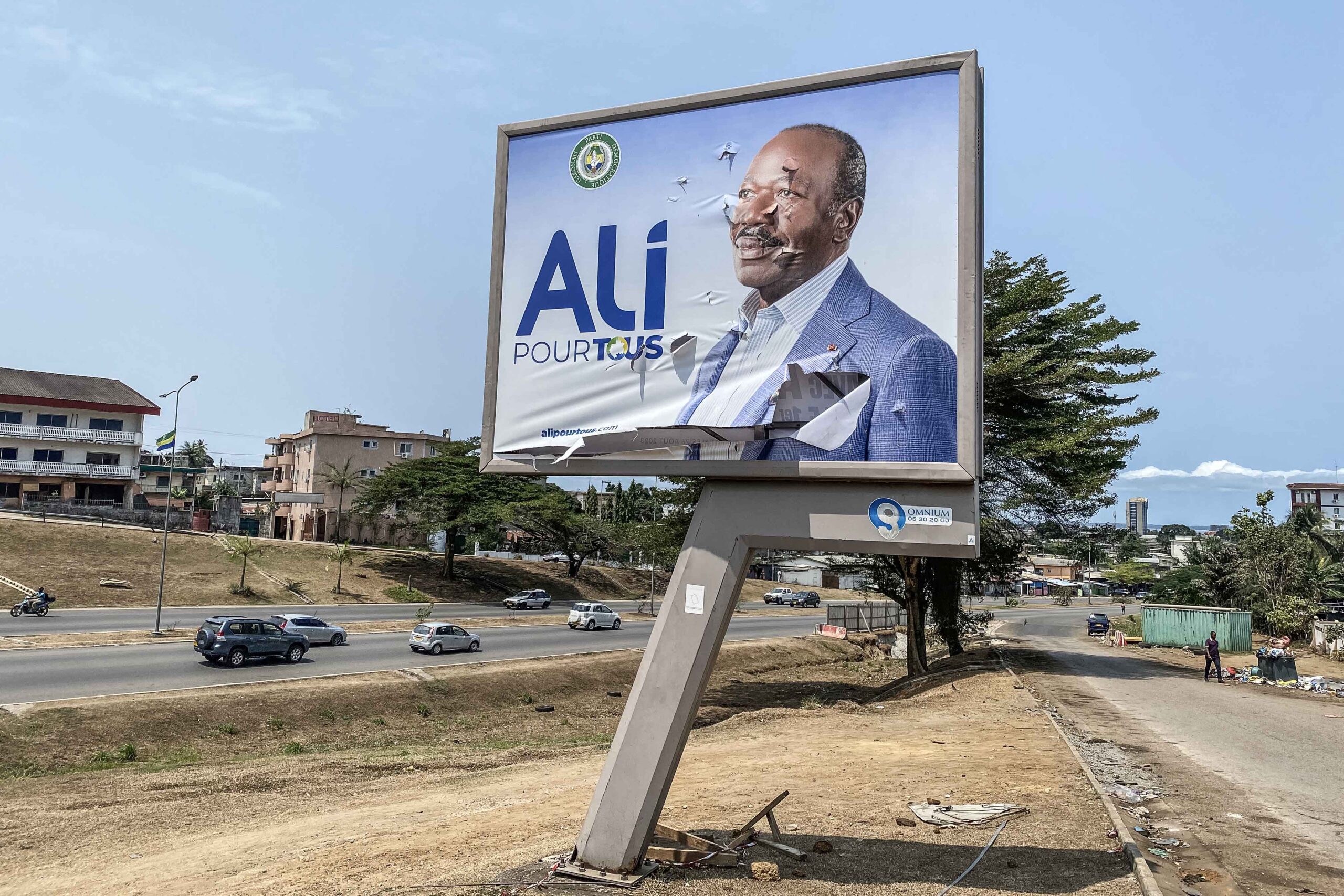 A general view of a torn campaign billboard of ousted Gabon President