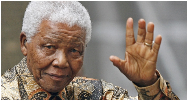 Former South African President Nelson Mandela waves to the media as he arrives outside 10 Downing Street, in central London, 28 August 2007, for a meeting with British Prime Minister Gordon Brown. Anti-apartheid hero Nelson Mandela has been seen as a moral compass in his home South Africa, but ten years after his death his legacy is vigorously debated, with some questioning the quality of the country's democracy.