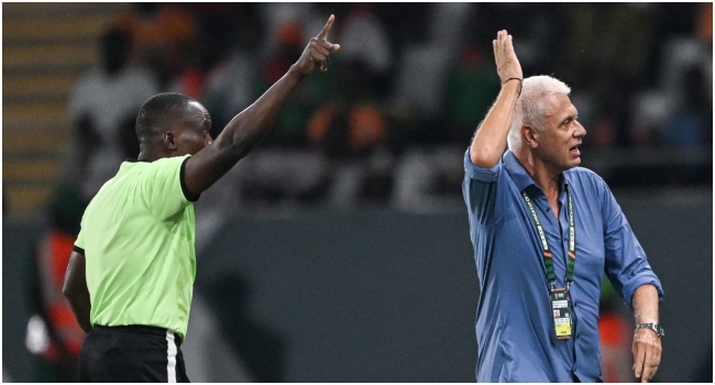 Burkina Faso's French coach Hubert Velud (R) reacts as he speaks with Congolese referee Jean-Jacques Ndala Ngambo (L) during the Africa Cup of Nations (CAN) 2024 group D football match between Angola and Burkina Faso at Stade Charles Konan Banny in Yamoussoukro on January 23, 2024. (