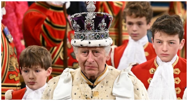 (FILES) Britain's King Charles III, wearing the Imperial State Crown and the Robe of State, processes through the Royal Gallery during the State Opening of Parliament at the Houses of Parliament in London on November 7, 2023.(Photo by JUSTIN TALLIS / POOL / AFP)