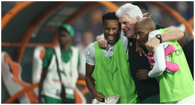 South Africa's head coach Hugo Broos (C) celebrates with South Africa's forward #11 Themba Zwane (L) and South Africa's defender #20 Khuliso Johnson Mudau after winning at the end of the Africa Cup of Nations (CAN) 2024 quarter-final football match between Cape Verde and South Africa at the Stade Charles Konan Banny in Yamoussoukro on February 3, 2024.
