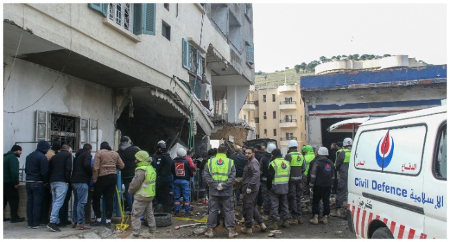 Rescuers check a building targeted overnight by an Israeli air strike in the southern Lebanese city of Nabatieh on February 15, 2024.  (Photo by Mahmoud ZAYYAT / AFP)