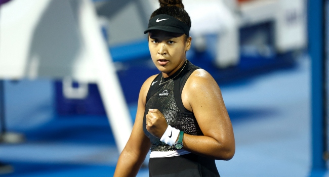 Japan's Naomi Osaka in action in the round of 32 match against Croatia's Petra Martic during their Women's Singles tennis match at the Qatar WTA Open at Khalifa International Tennis and Squash Complex in Doha on February 13, 2024. (Photo by Karim JAAFAR / AFP)