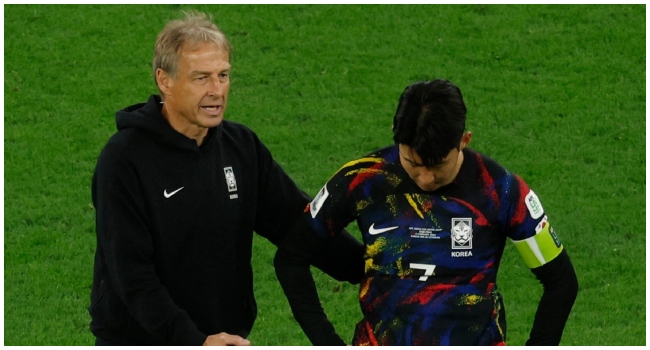 South Korea's German coach Jurgen Klinsmann speaks to midfielder #07 Son Heung-min after losing to Jordan at the end of the Qatar 2023 AFC Asian Cup semi-final football match between Jordan and South Korea at the Ahmad Bin Ali Stadium in Al-Rayyan, west of Doha on February 6, 2024.