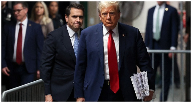 TOPSHOT - Former US President Donald Trump, with attorney Todd Blanche (L), walks toward the press to speak after attending his trial for allegedly covering up hush money payments linked to extramarital affairs, at Manhattan Criminal Court in New York City on April 23, 2024. (Photo by Yuki Iwamura / POOL / AFP)
