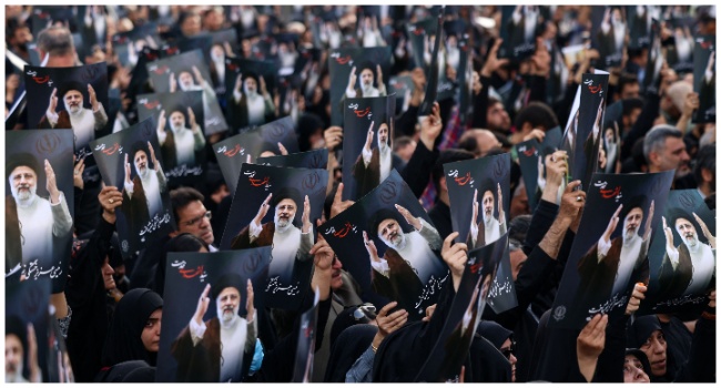 Iranians gather at Valiasr Square in central Tehran to mourn the death of President Ebrahim Raisi and Foreign Minister Hossein Amir-Abdollahian in a helicopter crash the previous day, on May 20, 2024. (Photo by ATTA KENARE / AFP)