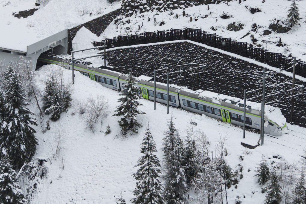 This aerial photograph shows a regional train derailed due to an avalanche in Goppenstein, southern Switzerland on February 16, 2026. (Photo by Louis DASSELBORNE / AFP)