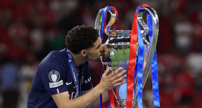 Paris Saint-Germain's Moroccan Defender #02 Achraf Hakimi kisses the trophy after winning UEFA Champions League on May 30, 2026. (Photo by AFP)
